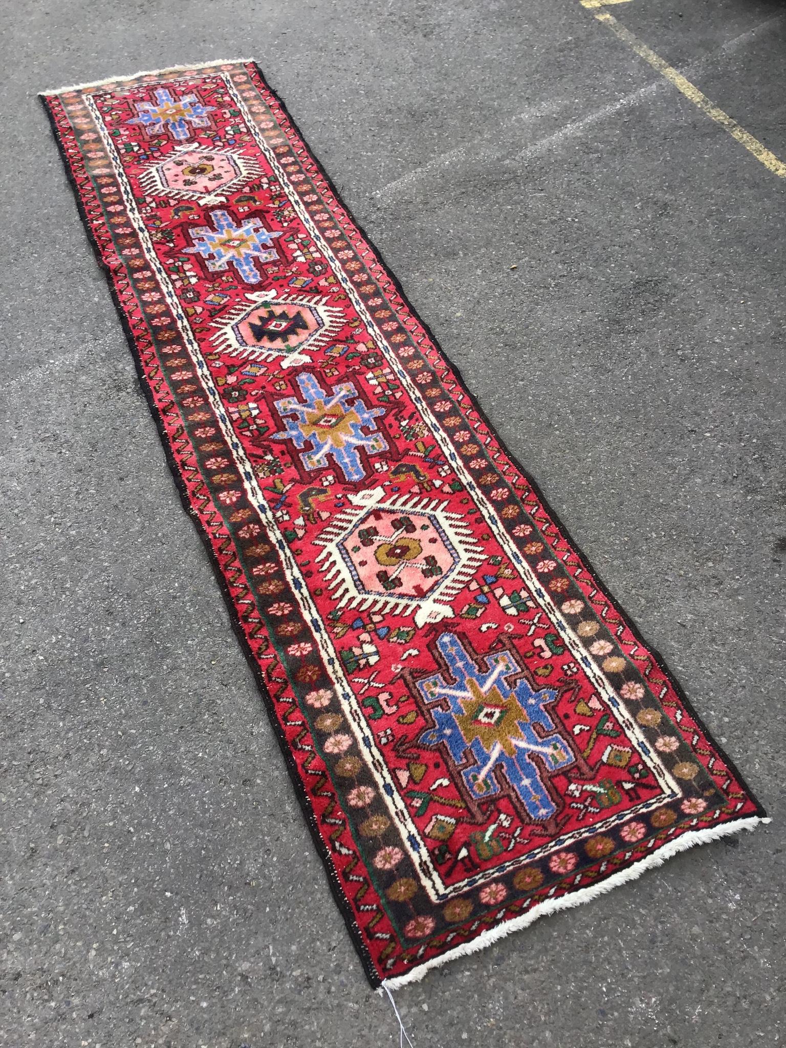 A Caucasian style red ground runner, 264 x 63cm